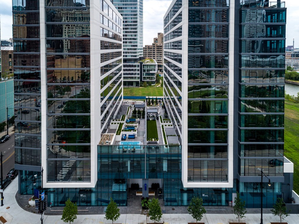 an aerial view of a city with tall buildings and a reflecting pool at The Grand Central, Chicago Illinois