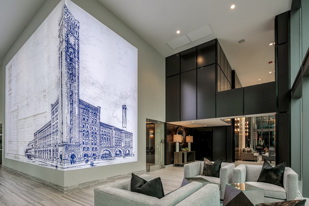 a living room with couches and a large painting on the wall at The Grand Central, Chicago