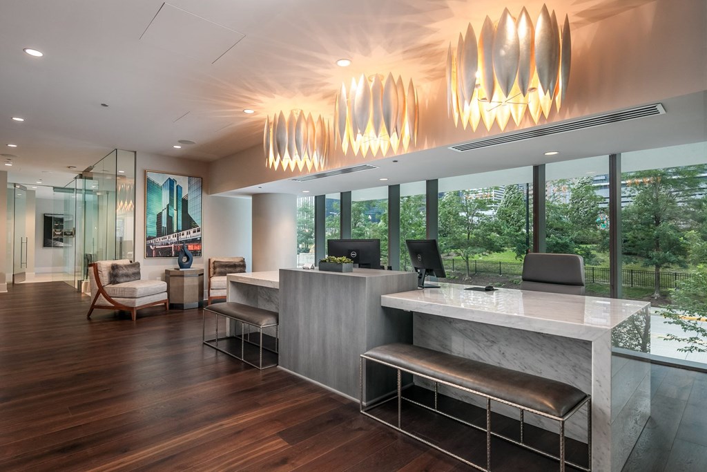 the lobby of a hotel with a reception desk and large windows at The Grand Central, Chicago Illinois