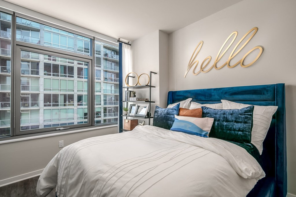 a bedroom with a bed and a large window at The Grand Central, Illinois, 60607