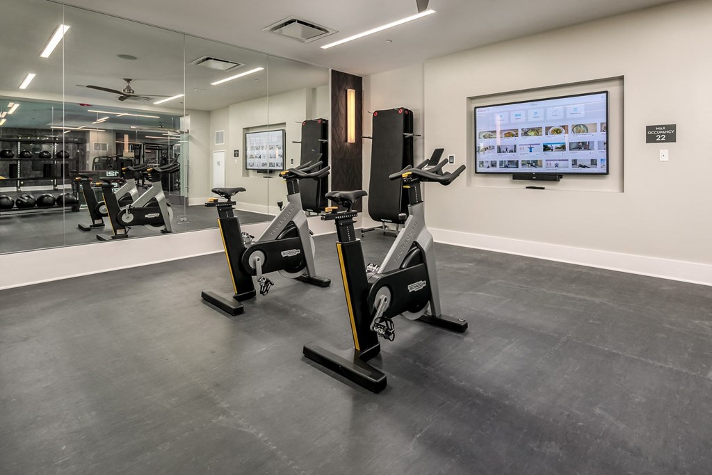 a gym with treadmills and other exercise equipment in a room with a tv at The Grand Central, Illinois