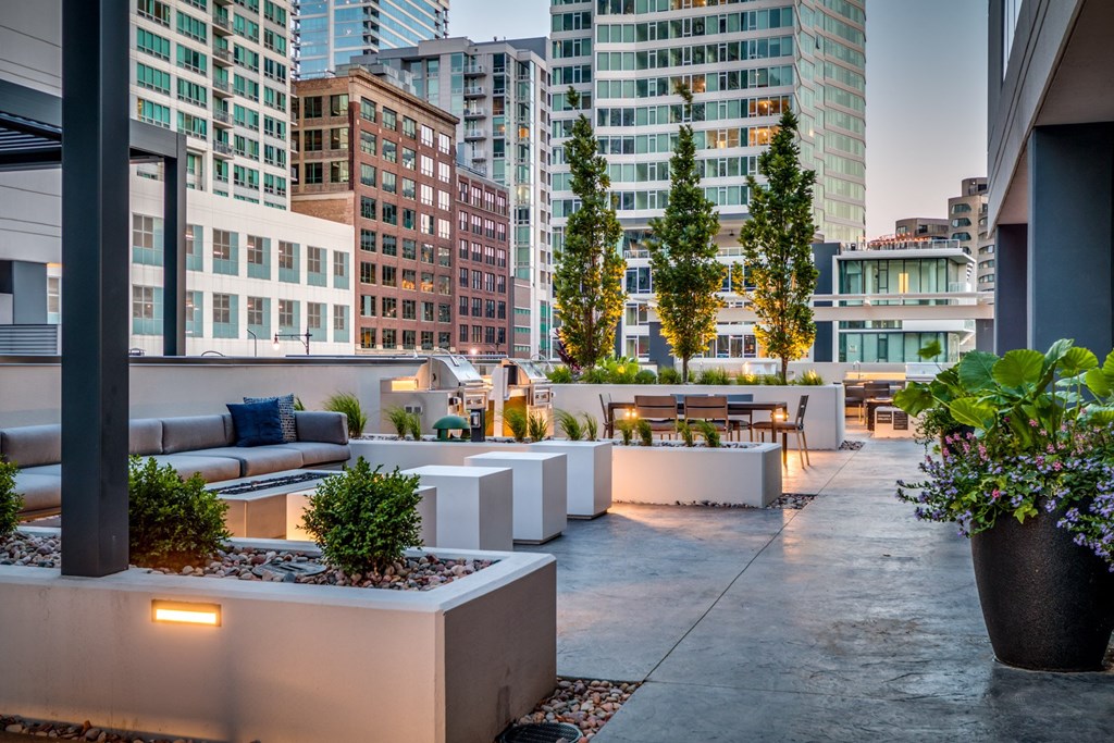 a terrace with couches and a table with plants at The Grand Central, Chicago, IL 60607