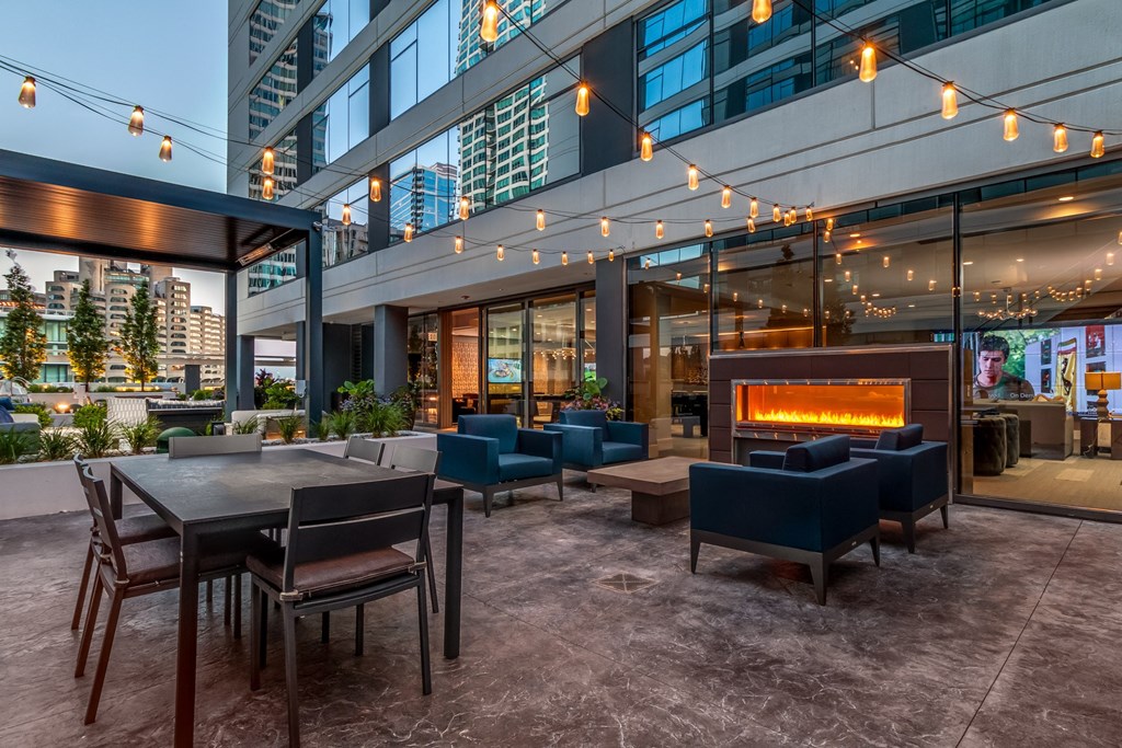 a lounge area with tables and chairs and a fireplace at The Grand Central, Chicago, IL