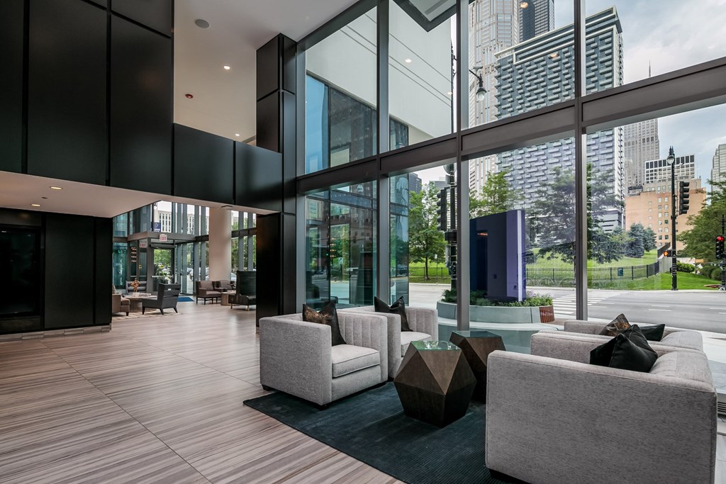 the living room has floor to ceiling windows and views of the city at The Grand Central, Chicago Illinois