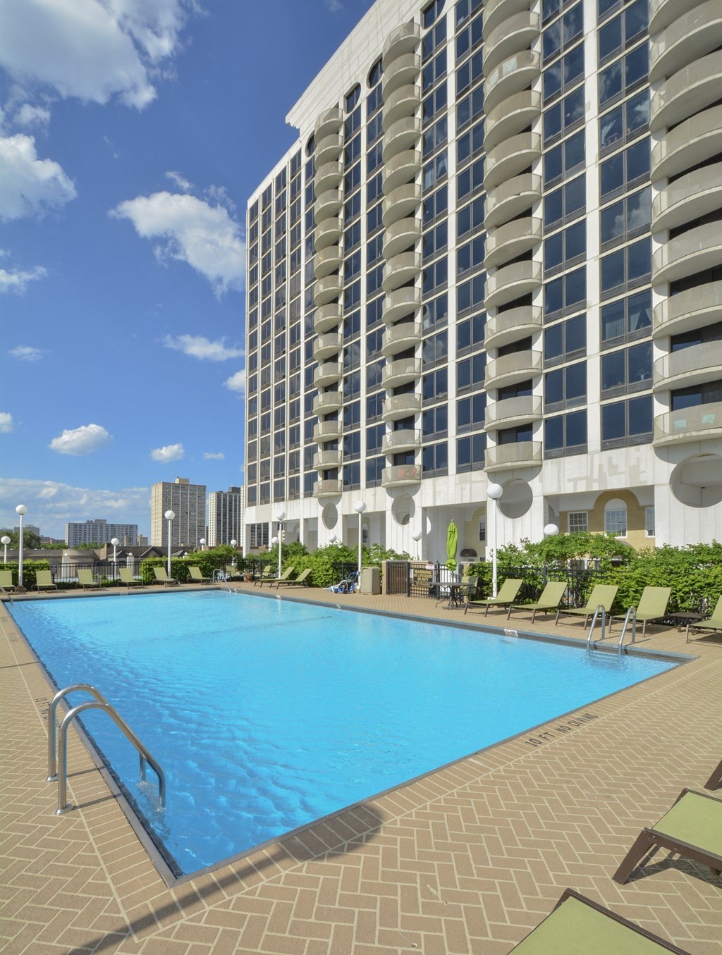 a large swimming pool in front of a tall building at The Montrose, Chicago, IL