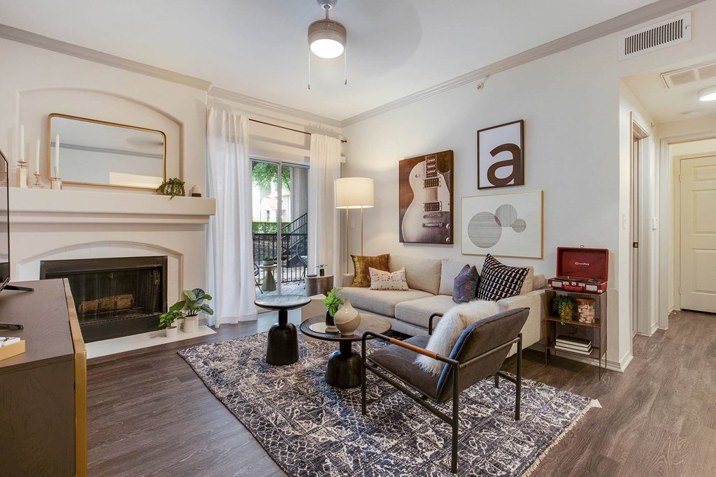 a living room with a couch and a fireplace at The Olivine, Austin, Texas