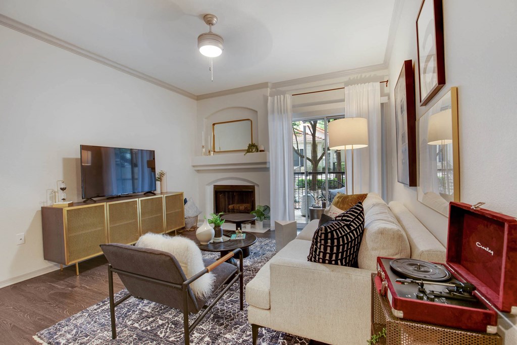 a living room with a white couch and a fireplace at The Olivine, Austin, Texas