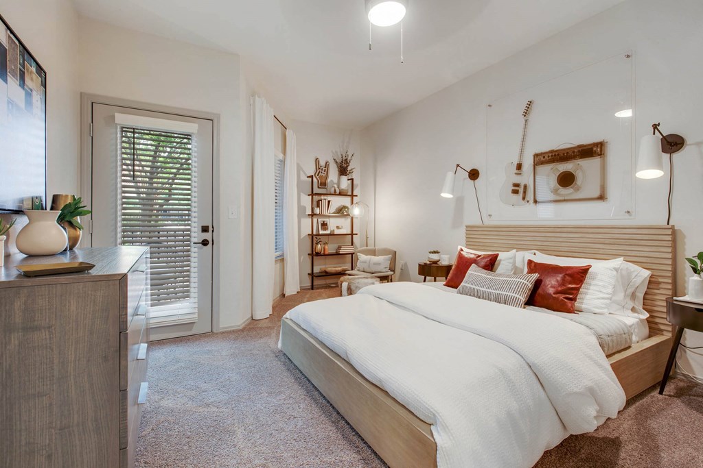 a bedroom with a bed and a door to a closet a bedroom with a bed and a door to a closet at The Olivine, Austin, Texas