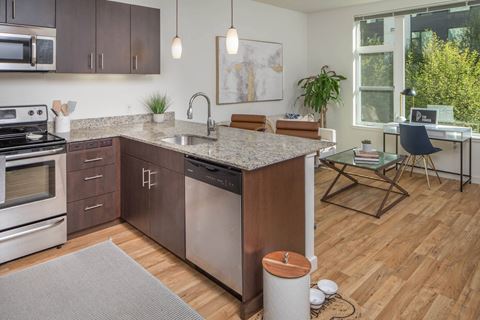 an open floor plan with a kitchen and living room at The Parker, Portland 97209