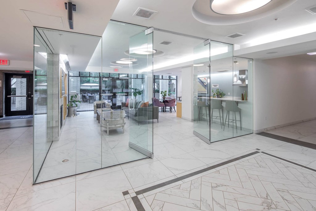 a large lobby with glass walls and a marble floor at The Parker Apartments, Oregon