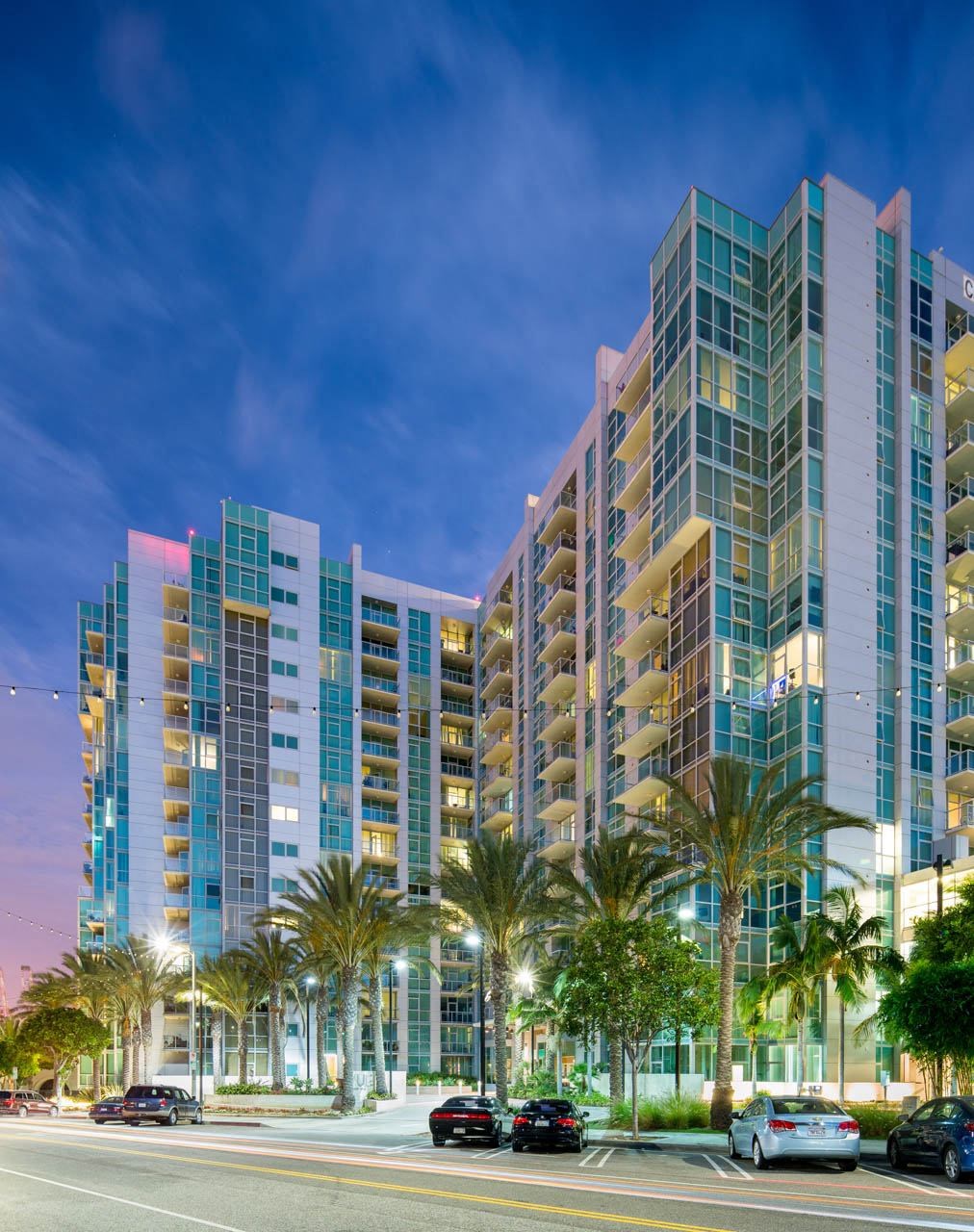 a view of a tall building at night with palm trees  at Vue, San Pedro, CA, 90731