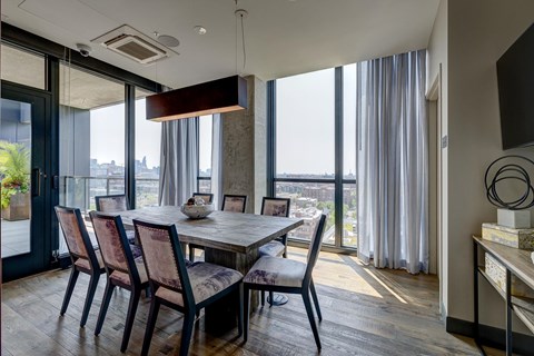 A modern dining room with a table set for four. at The Mason Apartments, Chicago, Illinois