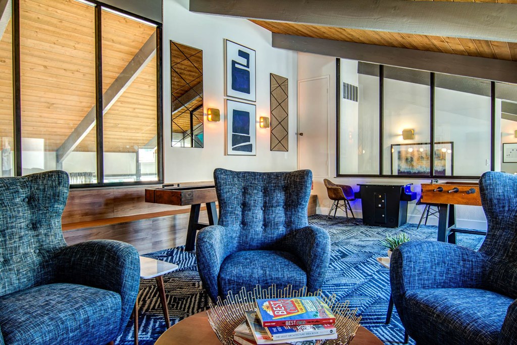 a living room with blue chairs and a table  at Veranda La Mesa, La Mesa, 91942