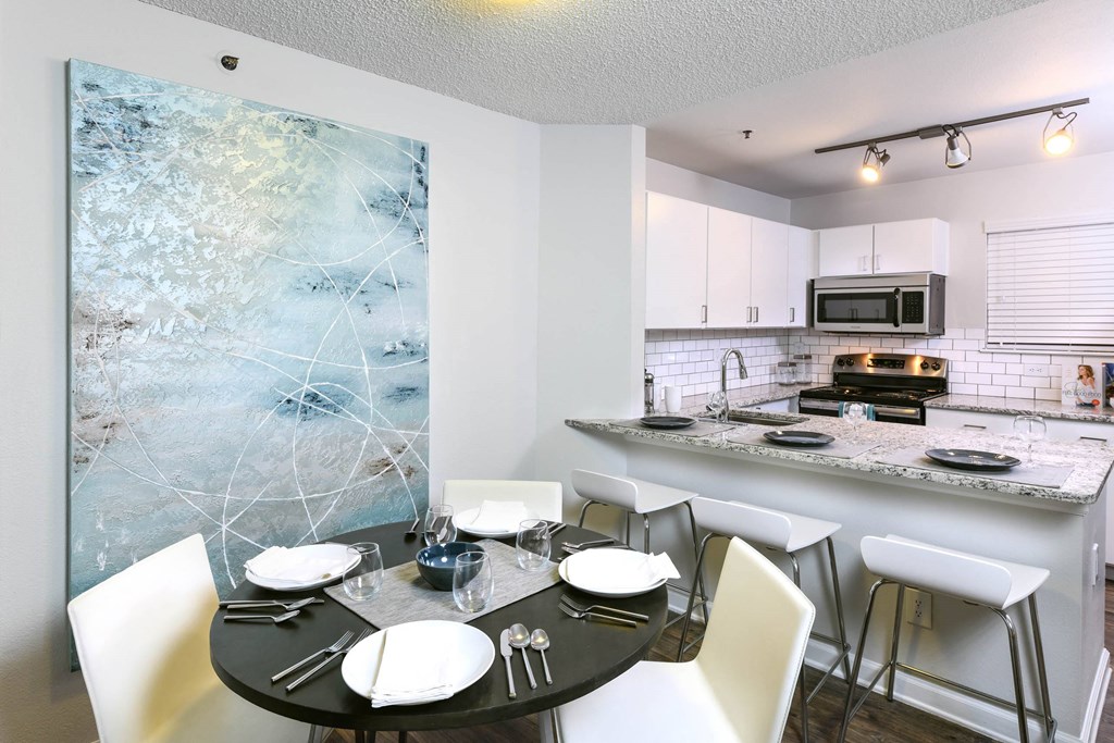 a kitchen and dining room with a table and chairs at Verdant, Boulder