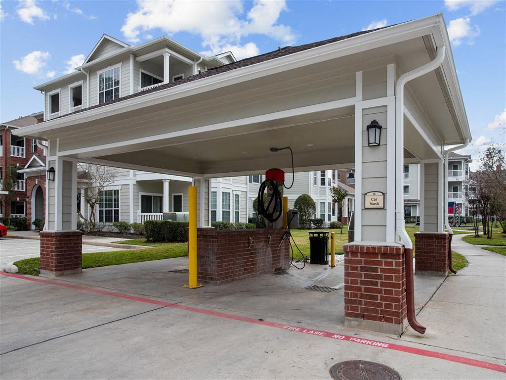 an empty gas station with a building in the background