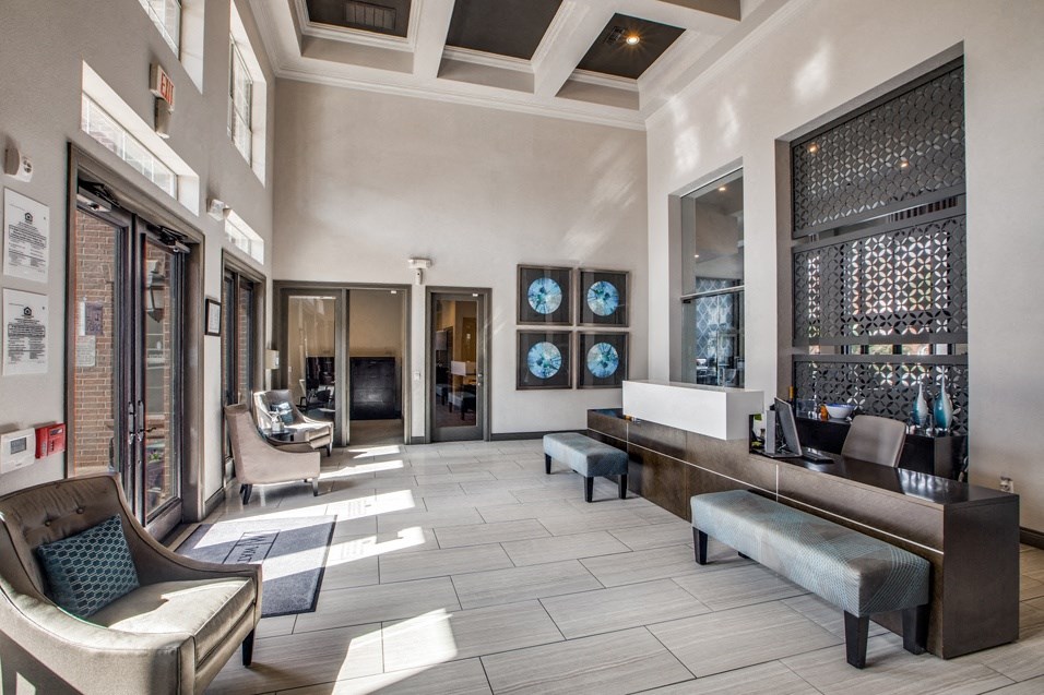 a lobby with a seating area and a reception desk