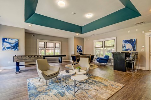 A living room with a pool table and a dining table.