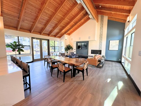 A dining room with a wooden table and chairs.