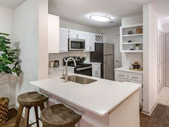 a kitchen with an island and a sink
