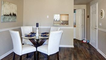 a dining room with a table and white chairs at 2000 Lake Washington Apartments, Washington, 98056