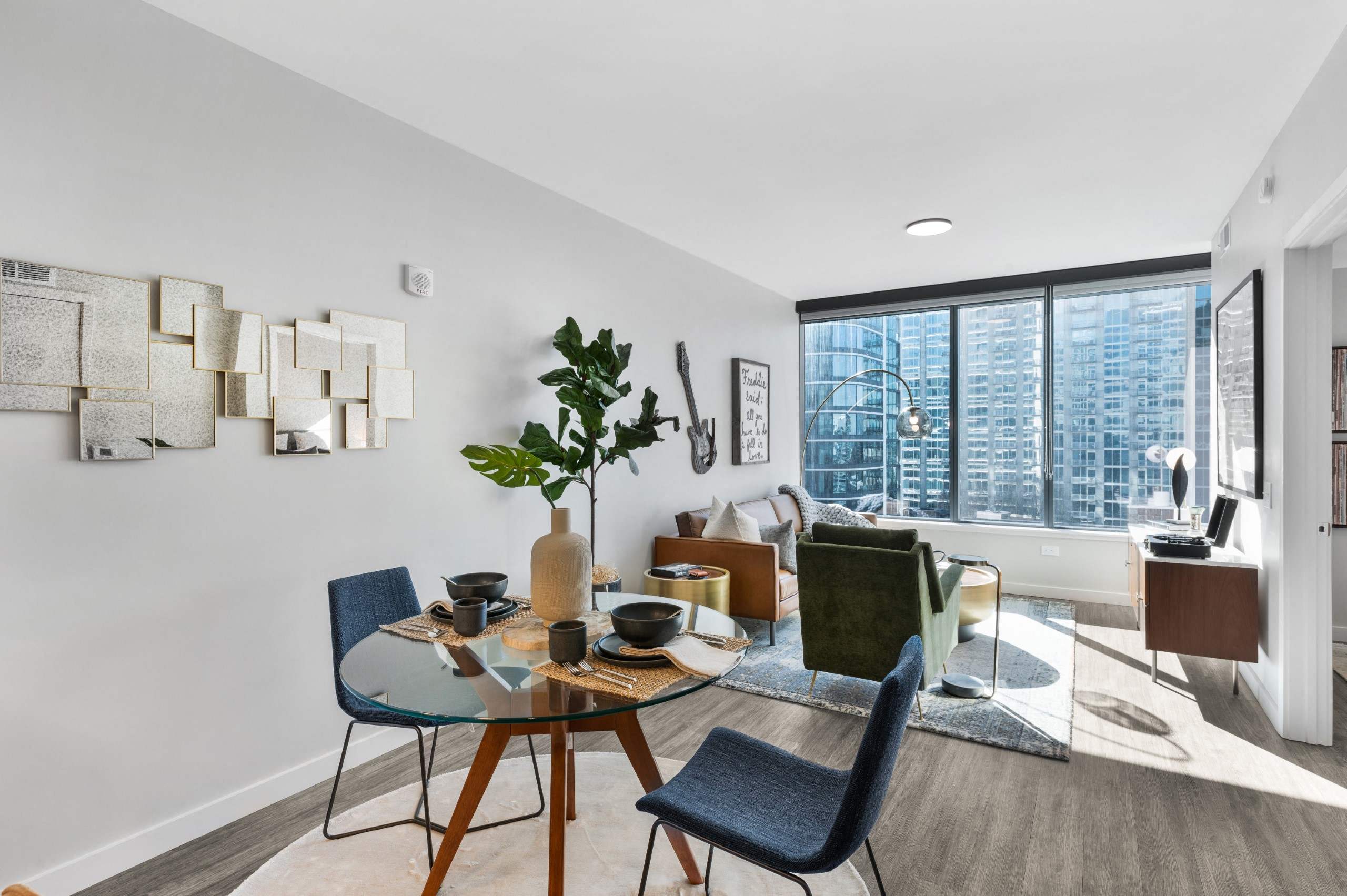 a living room with a table and chairs and a large window
