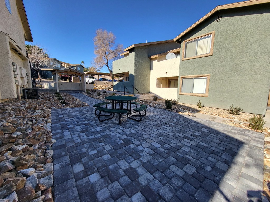 a patio with a picnic table in a courtyard at Sunset Winds Apartments in NV 89014