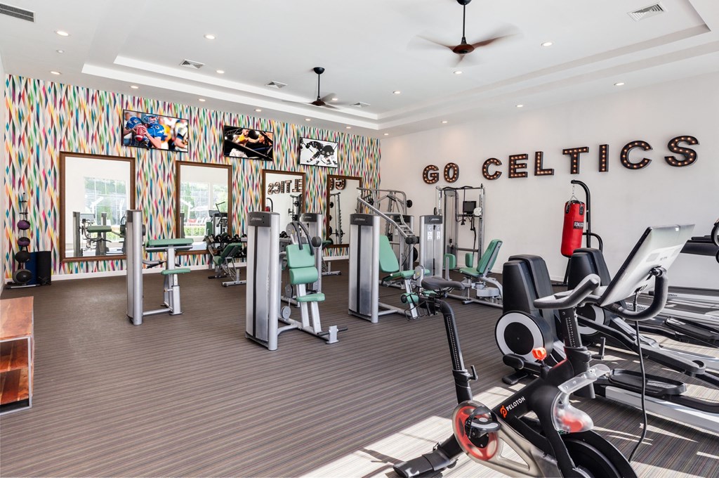 a gym with treadmills and other exercise equipment at Residences at Stevens Pond, Saugus