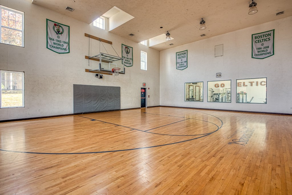 the inside the basketball court with wooden flooring at Residences at Stevens Pond, MA 01906