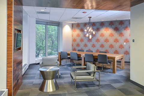 a conference room with a table and chairs and a large window at Presidential Towers, Chicago,60661