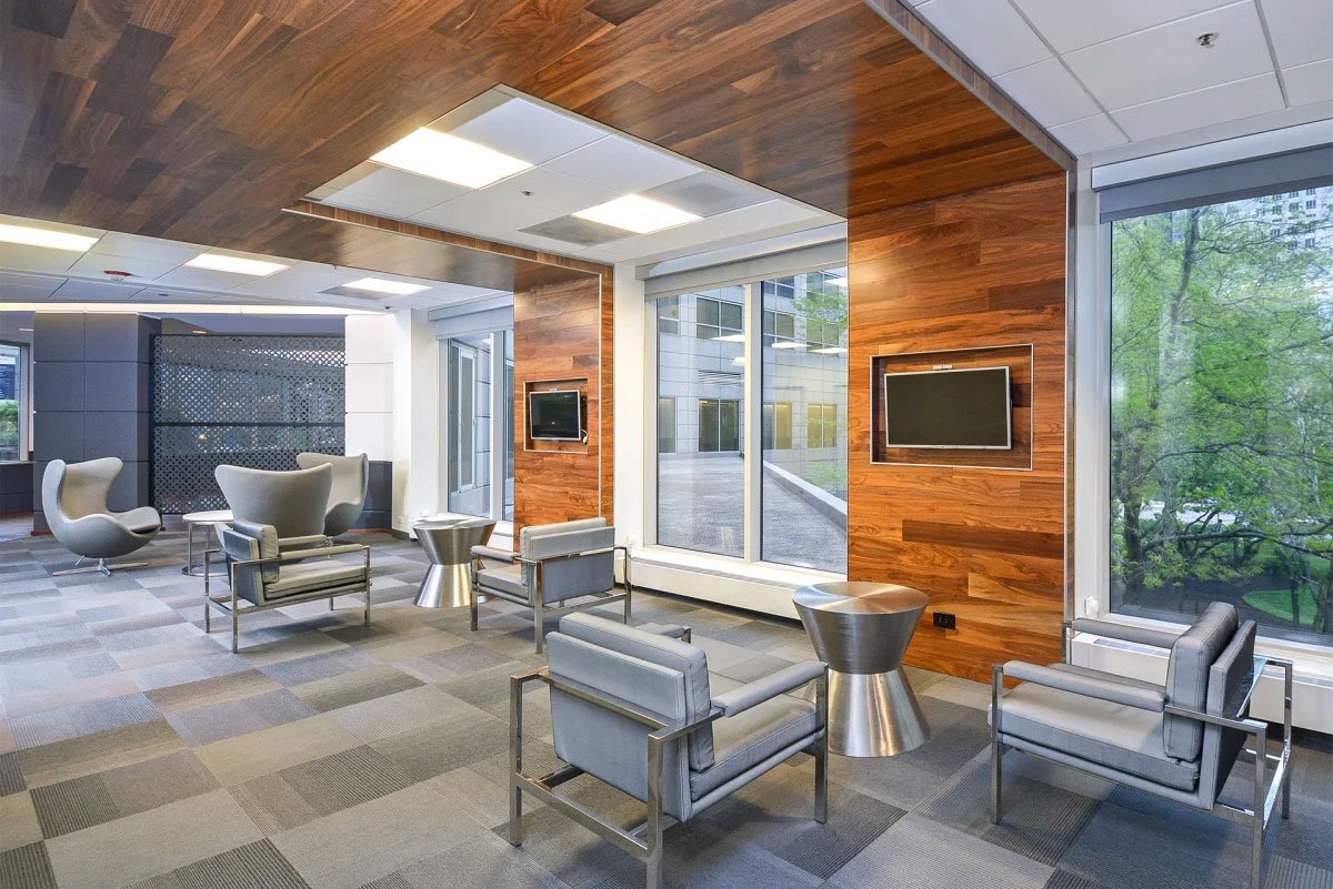 a waiting room in a hospital with chairs and a television