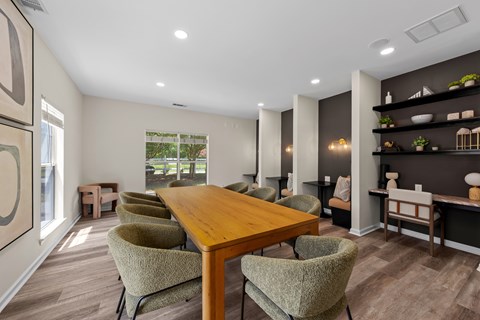 A dining room with a wooden table and chairs.