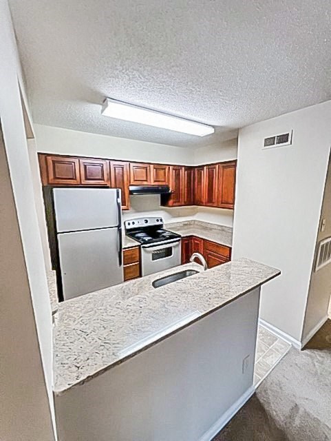 a kitchen with a stove and a refrigerator