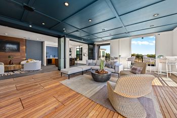 A modern living room with a wooden floor and a large window.