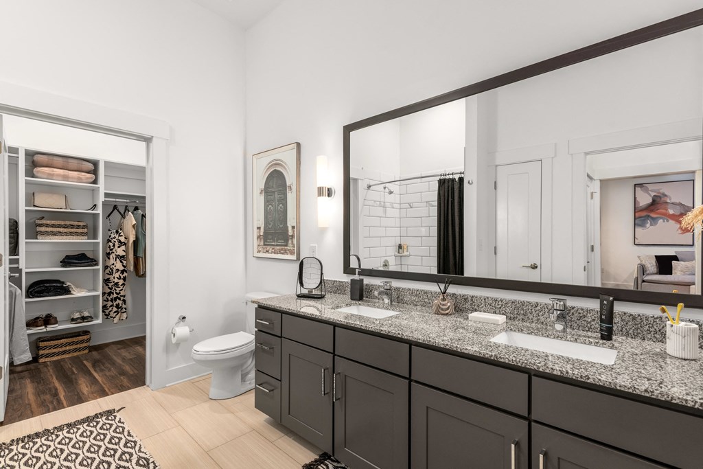 a bathroom with two sinks and a large mirror at The Colony, Charlotte, NC