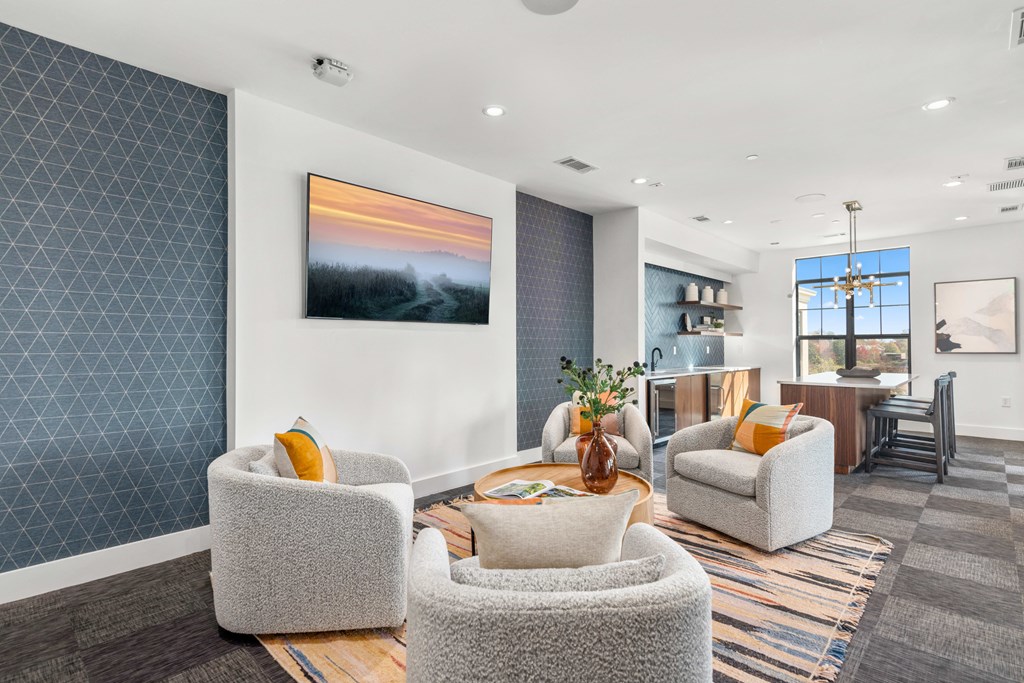 a living room with chairs and a table at The Colony, Charlotte, NC