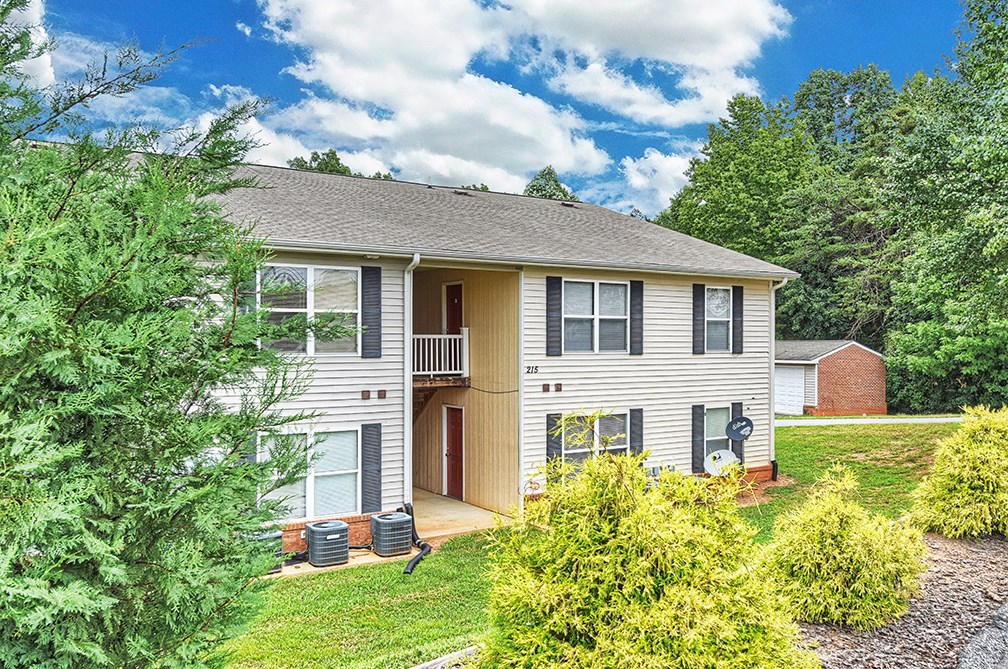 A two-story house with a brown door and a garage.