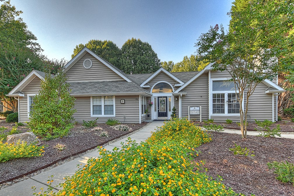 the front of a house with a sidewalk in front of it