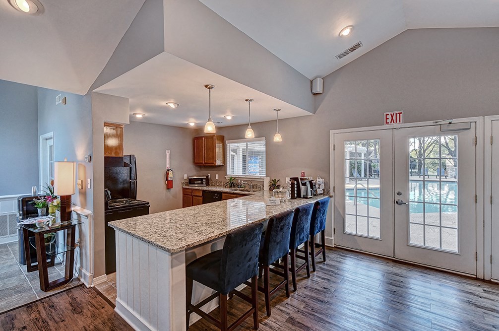 a kitchen with a long counter top and a door to a porch