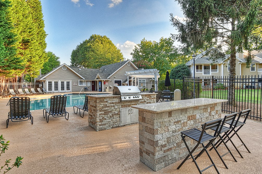 the preserve at ballantyne commons pool party area with patio furniture and a grill