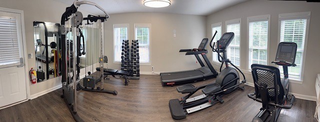 A spacious home gym with a variety of exercise equipment.