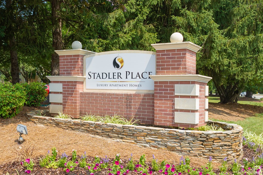 A sign for Stadler Place reads "Luxury Apartment Homes.".