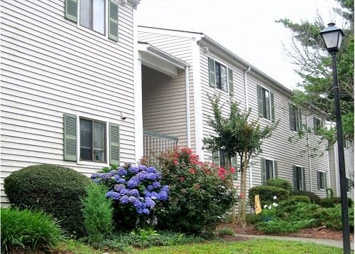 a white house with flowers in front of it
