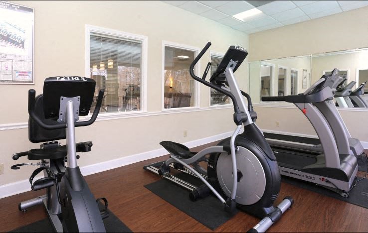 a gym with exercise equipment and a window