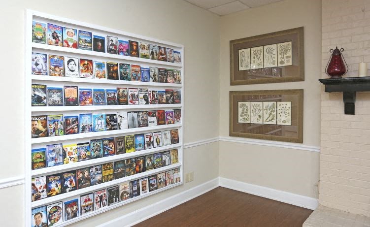 a room with a large wall of comics