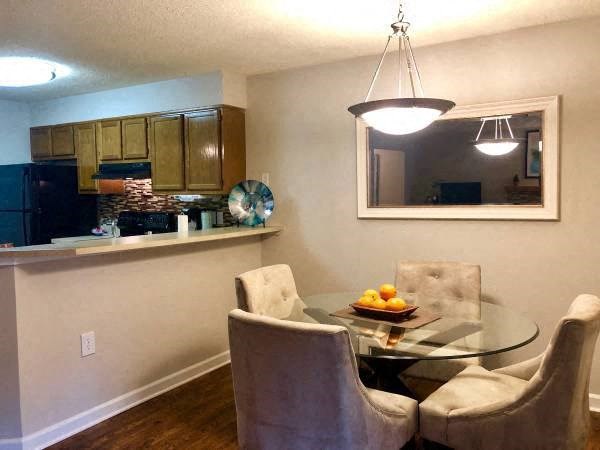a kitchen and dining room with a table and chairs