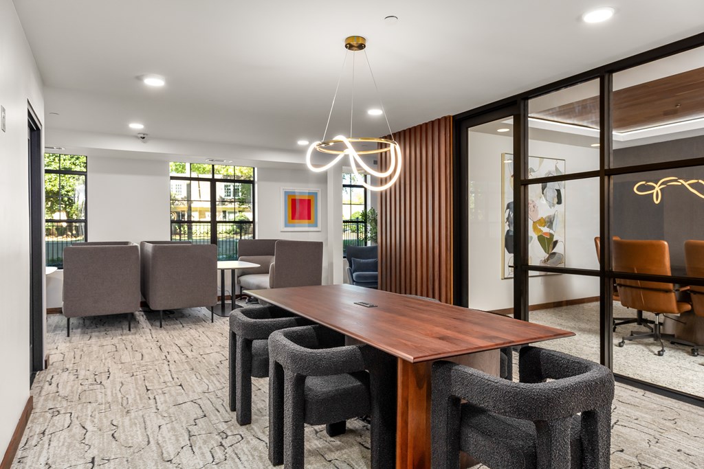 A conference room with a long table and chairs.