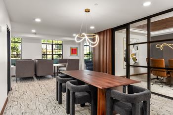 A conference room with a long table and chairs.