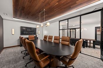 A conference room with a large table and chairs.
