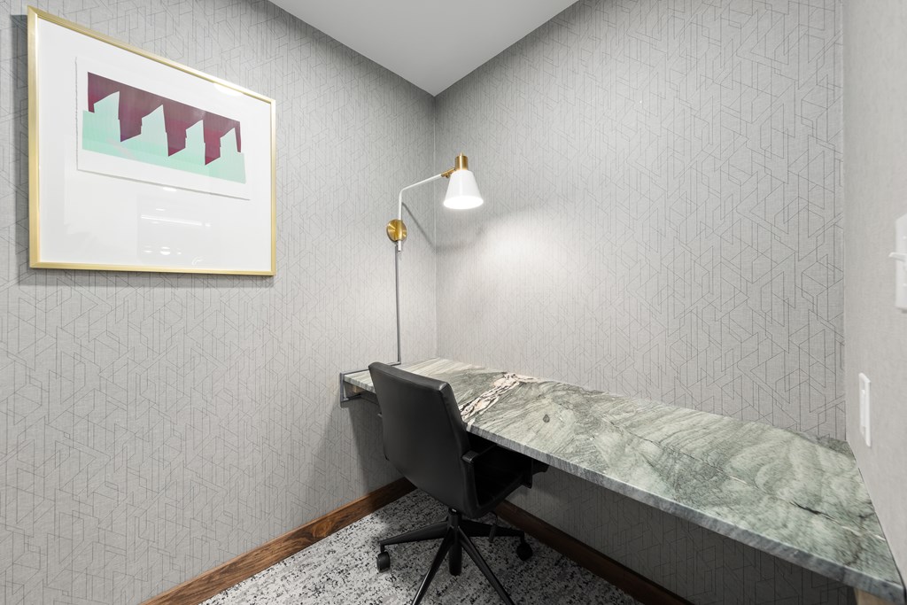 A room with a desk and a chair.