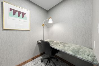 A room with a desk and a chair.